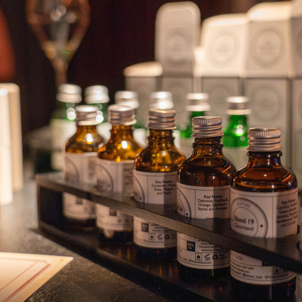 Perfume bottles and fragrance oils displayed for a party perfume making experience in the UK