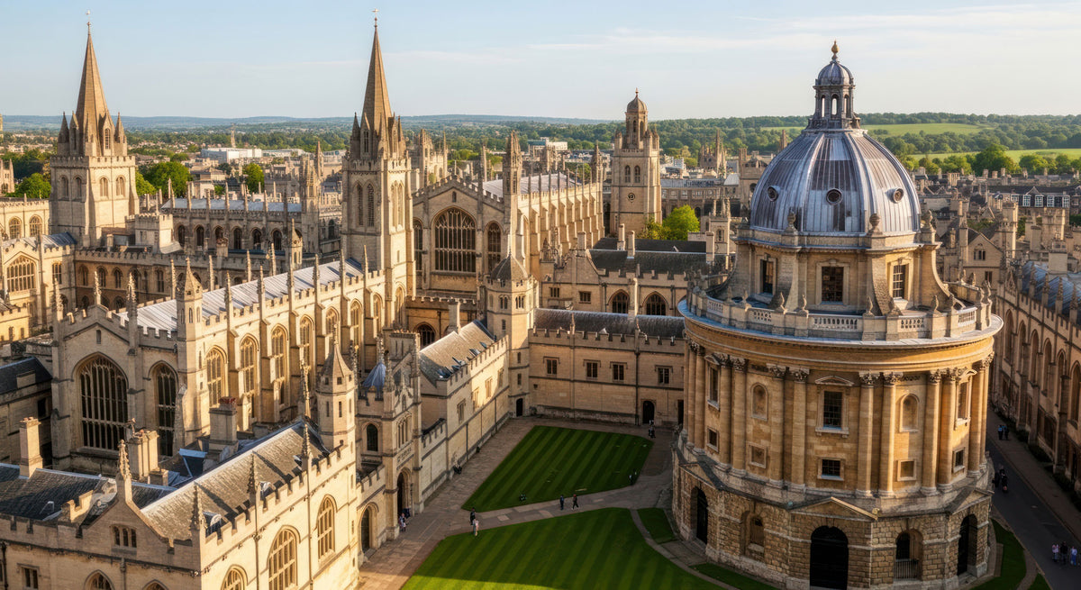 Aerial view of Oxford University architecture, featuring Radcliffe Camera with its distinctive dome, other historic stone buildings, green lawns, and distant fields under a clear sky, the perfect city to experience fragrance design.