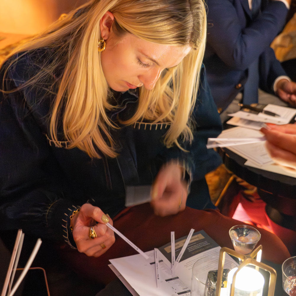 Party guest sampling fragrance blends during a birthday celebration party