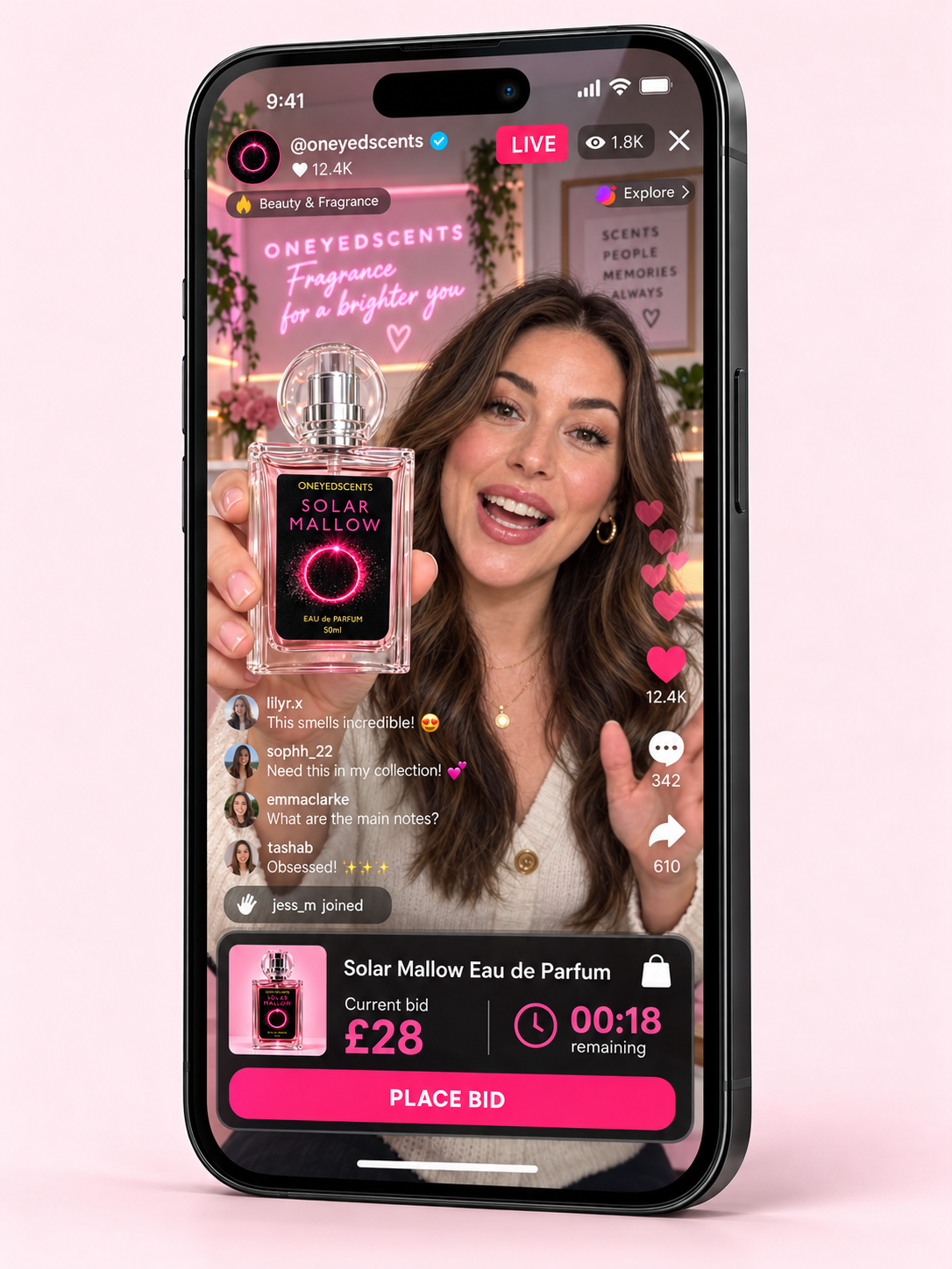 A smartphone mockup displays a live social media livestream promoting the Solar Mallow Eau de Parfum by One Eyed Scents. The screen shows a female host holding the perfume bottle, with pink and black graphics, while the phone is set against a solid light pink background.